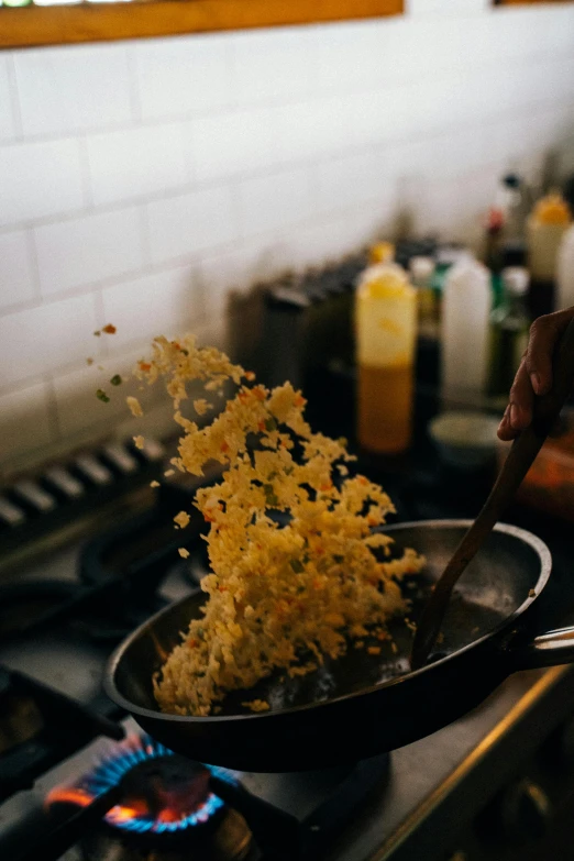 a person cooking food in a frying pan on a stove, unsplash, process art, yellow seaweed, award-winning crisp details”, mac and cheese, ignant