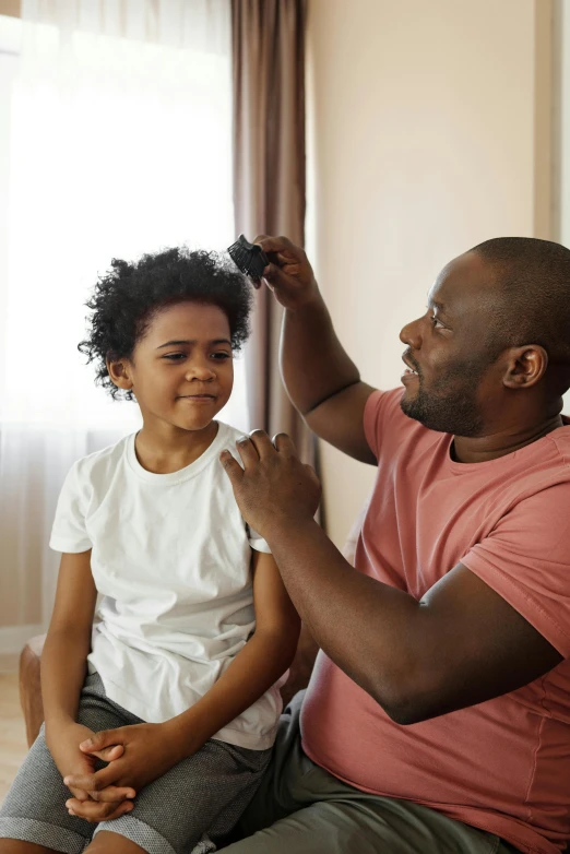 a man combing a little girl's hair, by Samuel Washington Weis, pexels contest winner, black teenage boy, eeg nodes on scalp, slide show, fatherly