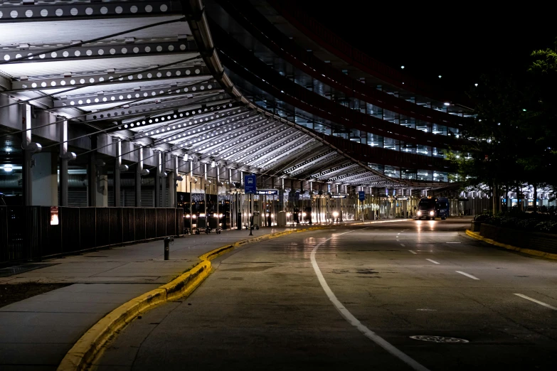 a city street filled with lots of traffic at night, unsplash, bauhaus, airport, chicago, deserted, canopies