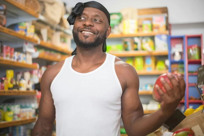 a man holding an apple in a grocery store, a portrait, pexels contest winner, renaissance, african aaron paul, beefcake pose, avatar image