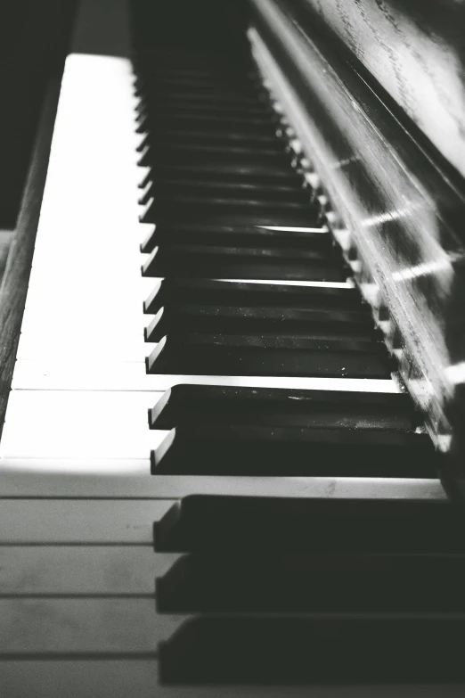 a black and white photo of a piano, and you fade away just enough, lofi feel, key is on the center, ivory and ebony