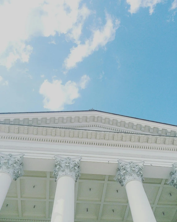 a clock that is on the side of a building, an album cover, by Carey Morris, trending on unsplash, neoclassicism, light blue sky with clouds, colonnade, grand library, lgbtq