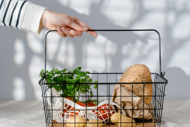 a person holding a basket of food on a table, pexels contest winner, clean and simple design, getting groceries, wireframe models, background image