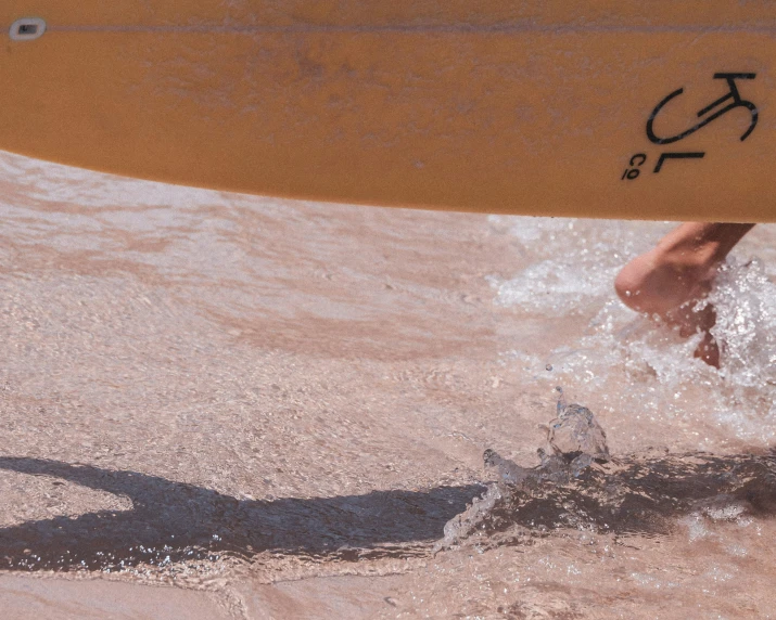 a person walking into the water with a surfboard, pexels contest winner, plasticien, brown mud, website banner, moab, up-close