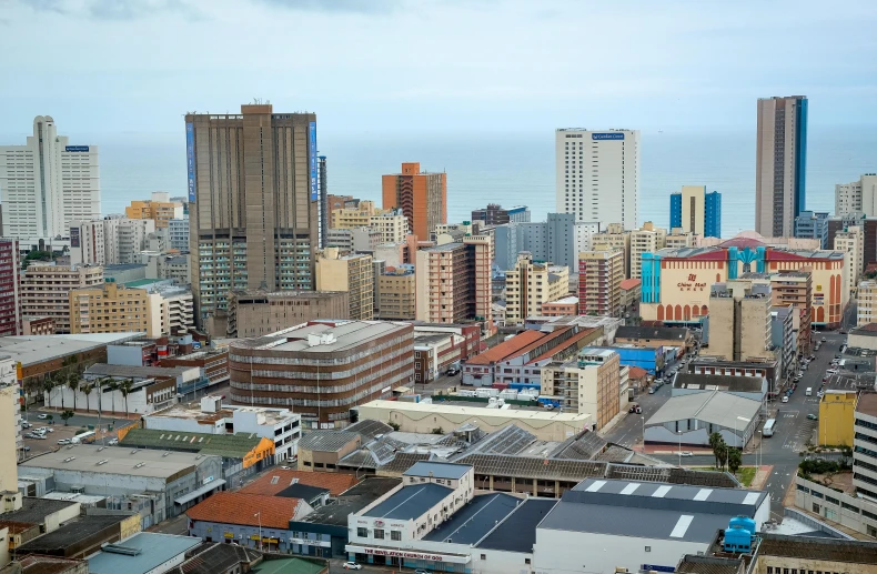 a view of a city from the top of a building, inspired by Joze Ciuha, pexels contest winner, hyperrealism, south african coast, buffalo, slide show, slight overcast lighting