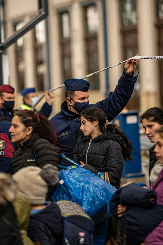 a group of people sitting next to each other, police tape, holding a baguette, masks on wires, romanian heritage