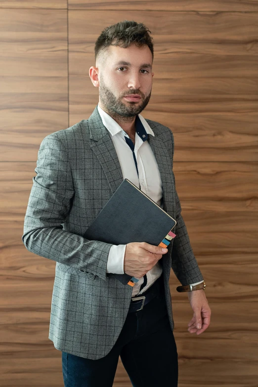 a man in a suit and tie holding a folder, by Koloman Sokol, pexels contest winner, renaissance, wearing business casual dress, masculine appeal high fashion, scruffy man, hasbulla magomedov
