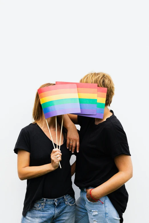 a man and a woman holding a rainbow flag, a cartoon, trending on unsplash, antipodeans, on a gray background, color photograph, multiple stories, brown