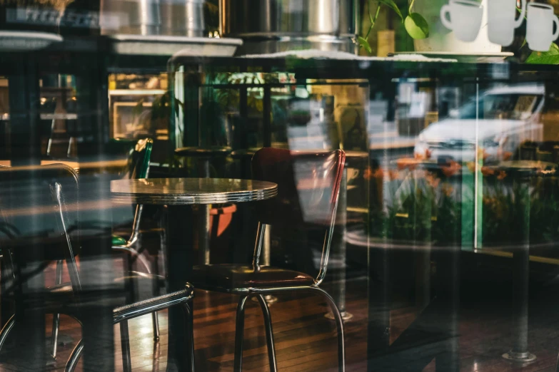 a table and chairs in front of a window, by Emma Andijewska, pexels contest winner, modernism, aussie baristas, neon reflections, laquer and steel, thumbnail