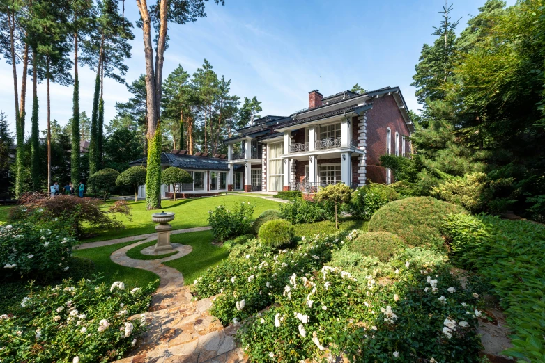 a large house sitting in the middle of a lush green yard, inspired by Edward Willis Redfield, unsplash, bauhaus, style of ivan shishkin, lush plants and bonsai trees, rose garden, high-quality photo