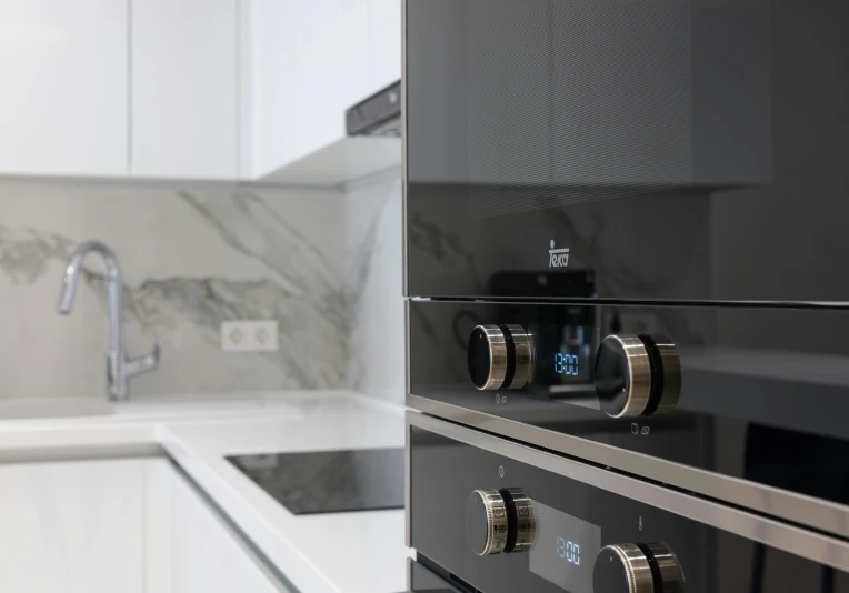 a stove top oven sitting inside of a kitchen, by Niko Henrichon, silver details, neo kyiv, glossy white, high-quality photo