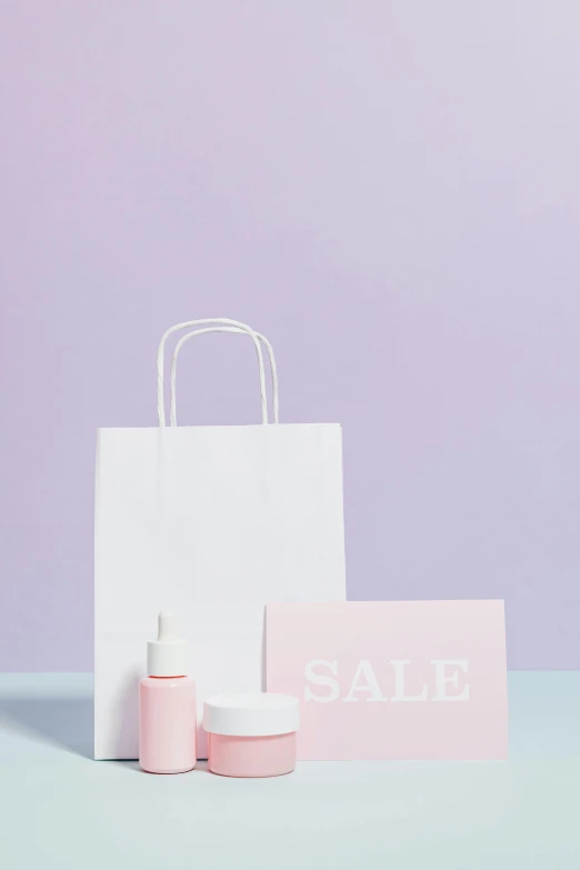 a white shopping bag sitting on top of a table, by Adam Saks, pexels contest winner, aestheticism, pastel purple background, skincare, square, female outfit