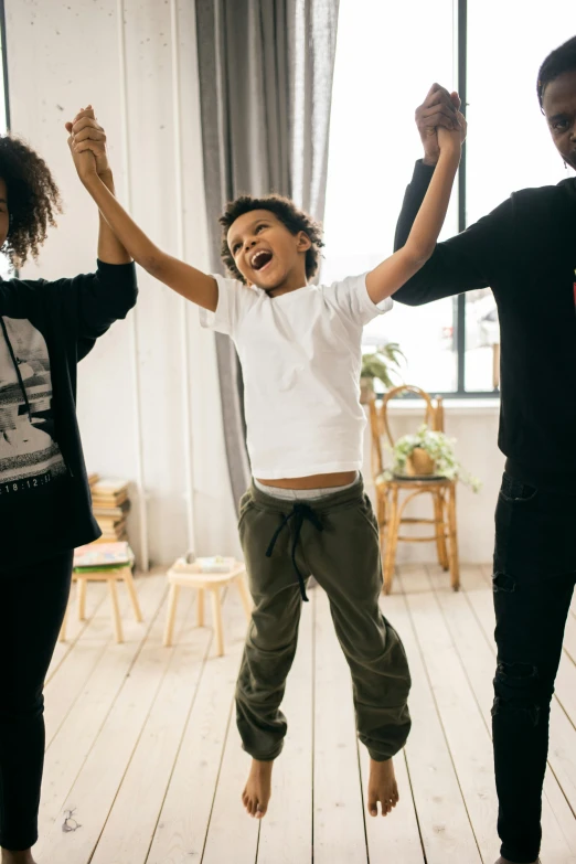 a group of people jumping in the air, inspired by The Family Circus, pexels contest winner, black arts movement, portrait of family of three, line dancing at a party, little boy, feels good man