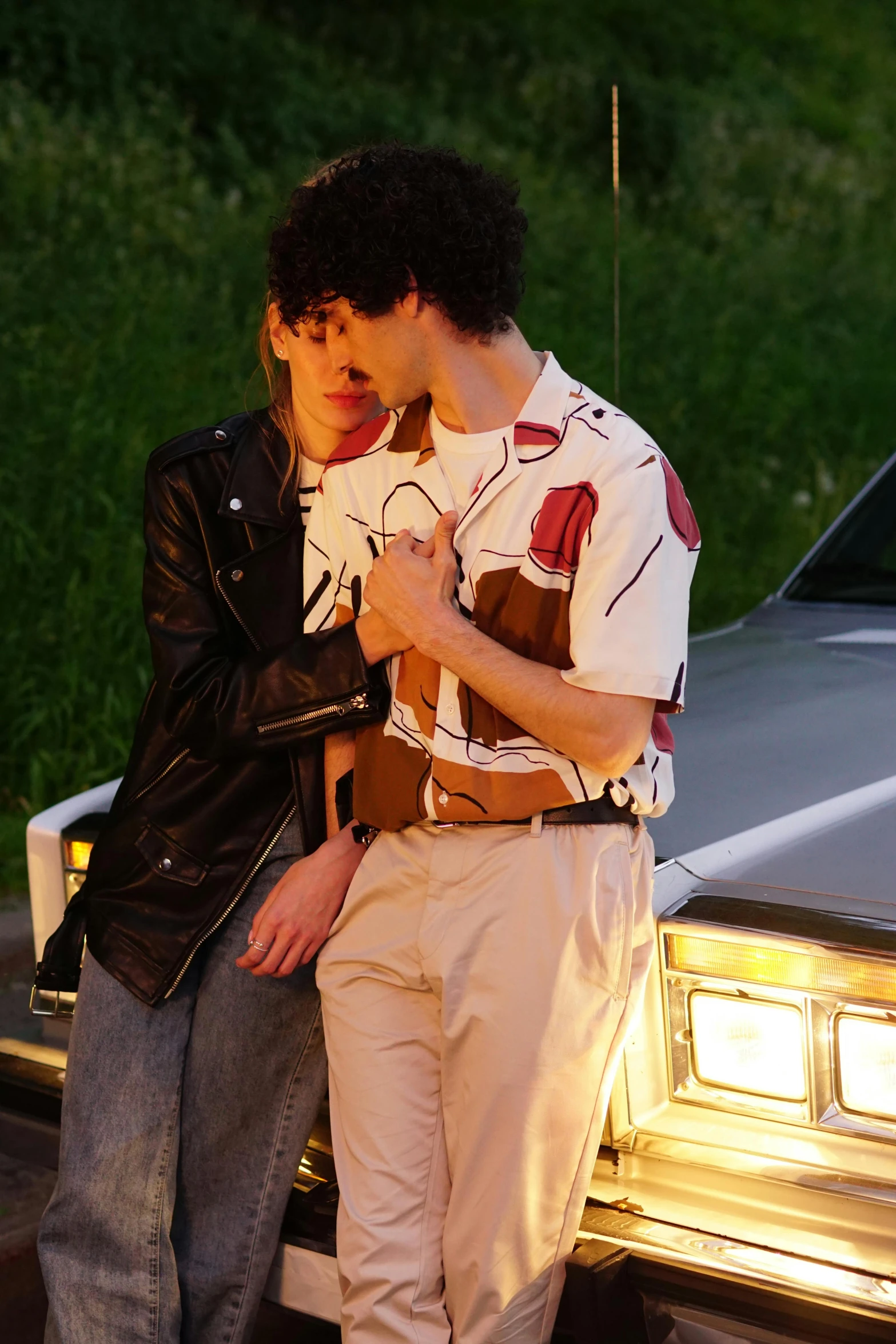 a couple of men standing next to a car, inspired by Nan Goldin, trending on pexels, renaissance, cropped shirt with jacket, making love, ( ( theatrical ) ), skins