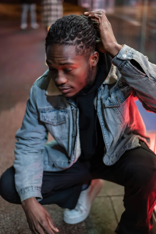a man crouching down next to a fire hydrant, an album cover, by Charles Martin, trending on pexels, wearing a jeans jackets, playboi carti portrait, lights on, headshot profile picture
