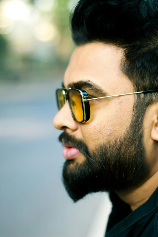 a close up of a man with a beard and sunglasses, by Max Dauthendey, pexels contest winner, hurufiyya, profile pic, yellow hue, square masculine facial features, 5 feet away