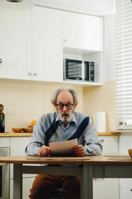 a man sitting at a kitchen table reading a paper, by Morris Kestelman, pexels contest winner, hyperrealism, in australia, man with beard, still from a live action movie, christopher lloyd as belial