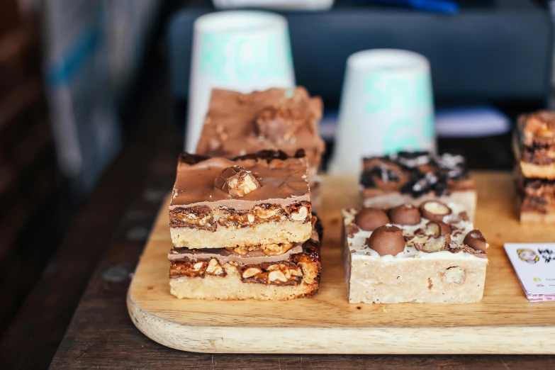 a close up of a tray of food on a table, by Lee Loughridge, unsplash, hurufiyya, mars candy bars, square, aussie baristas, 9 9 designs