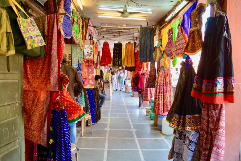 a store filled with lots of different types of clothing, a picture, trending on unsplash, on an indian street, square, colorful”