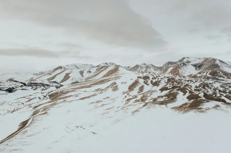 a man riding skis down a snow covered slope, a detailed matte painting, inspired by Filip Hodas, unsplash contest winner, hyperrealism, view from helicopter, unreal engine 5 render 16k, chile, muted colors. ue 5