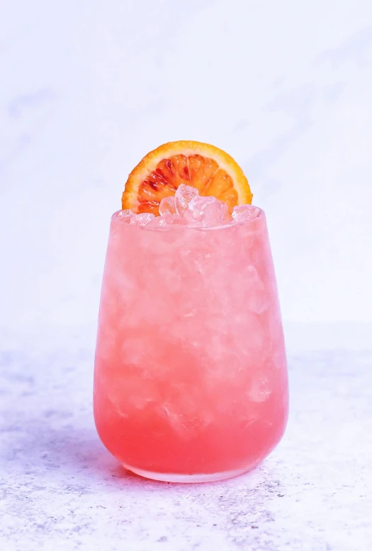 a pink drink with a slice of orange on top of it, a portrait, volcanic, three quarter profile, battered, velma