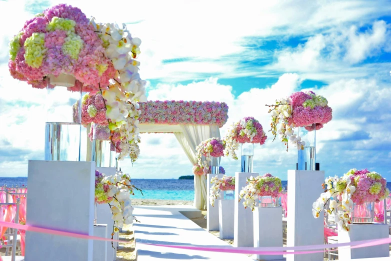 a wedding ceremony set up on the beach, a cartoon, unsplash, romanticism, heaven pink, thumbnail, flowers everywhere, perfect crisp sunlight