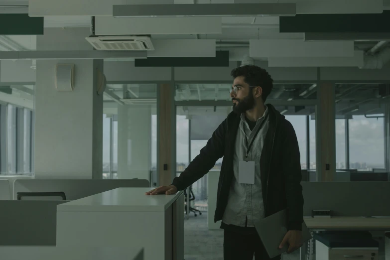 a man standing next to a desk in an office, a detailed matte painting, unsplash contest winner, still frame from a movie, h3h3, man walking, concerned