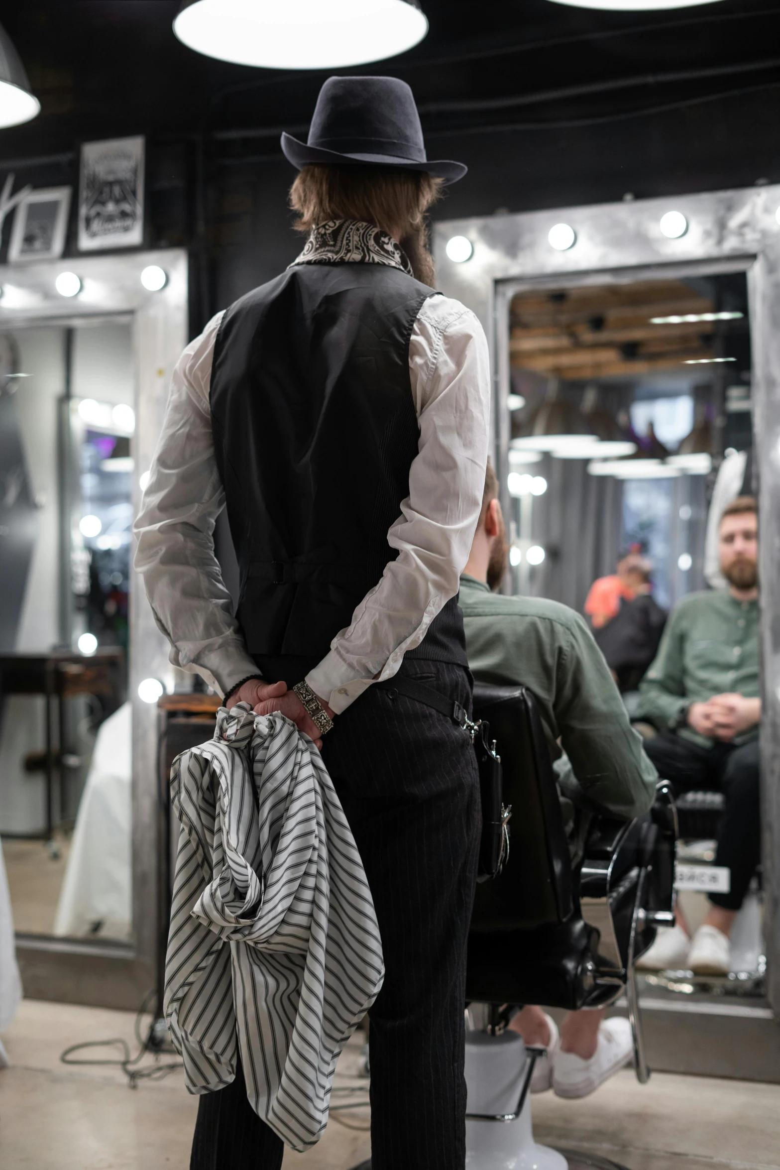 a man standing in front of a barber shop, by Jaakko Mattila, trending on unsplash, sitting in a wheelchair, showing her shoulder from back, at checkout, wearing a vest