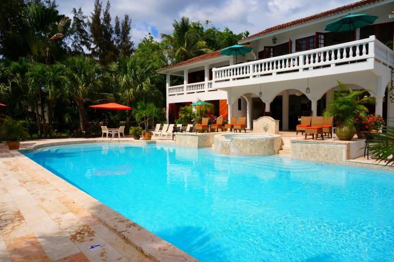 a house with a swimming pool in front of it, by Carey Morris, pexels, tropical pool, colonial, al fresco, many exotic high end features