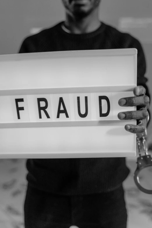 a man holding a sign that says fraud, a black and white photo, by Giorgio Cavallon, pexels contest winner, fluxus, cracks, avatar image, confidential documents, crypto