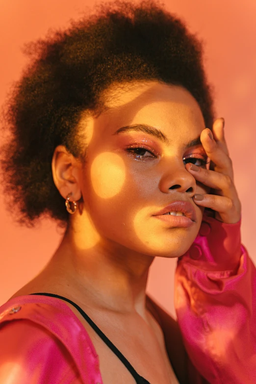 a woman holding a cell phone to her ear, an album cover, pink and orange colors, looking off to the side, dark natural glow, bella poarch