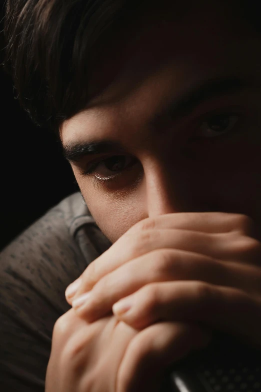 a close up of a person holding a remote, by Eglon van der Neer, trending on pexels, renaissance, portrait of depressed teen, handsome man, sitting with wrists together, contemplating