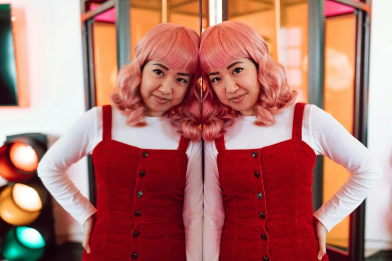 two women standing next to each other in front of a mirror, an album cover, inspired by Yuko Tatsushima, tumblr, wearing pink hair bow, wearing a red outfit, youtube thumbnail, joy ang