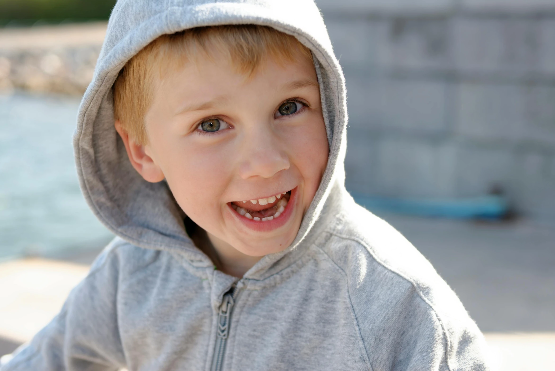 a close up of a child wearing a hoodie, short light grey whiskers, having fun in the sun, boys, all teeth