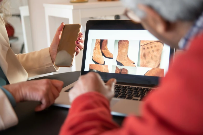 a couple of people that are sitting in front of a laptop, a photo, by Matthias Stom, renaissance, wears brown boots, ebay listing thumbnail, mobile learning app prototype, closeup photograph