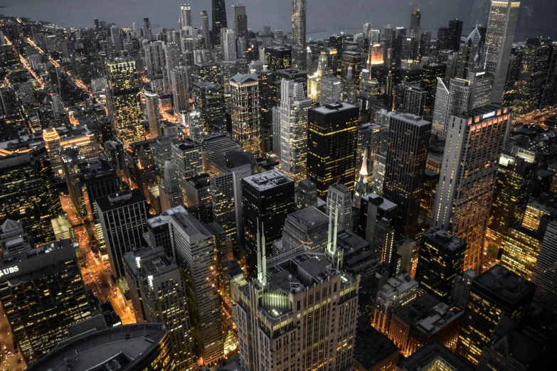 an aerial view of a city at night, by Greg Rutkowski, pexels contest winner, chicago, buildings covered with greebles, fine art print, highly detailded'