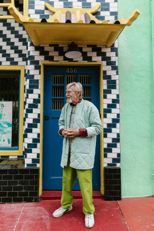 a man standing in front of a colorful building, old lady, with teal clothes, sydney hanson, doors