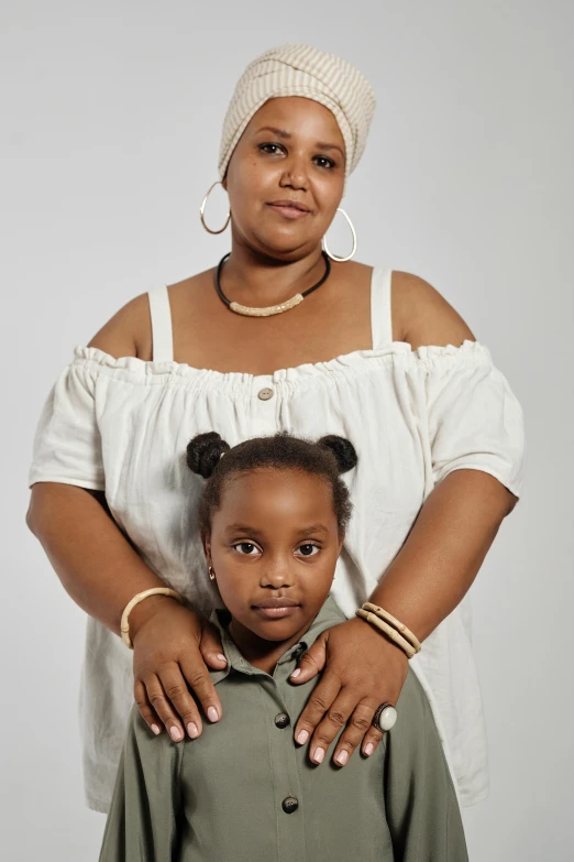 a woman and a child posing for a picture, an album cover, inspired by Sophia Beale, pexels contest winner, an all white human, plus size, studio portrait, ( ( brown skin ) )