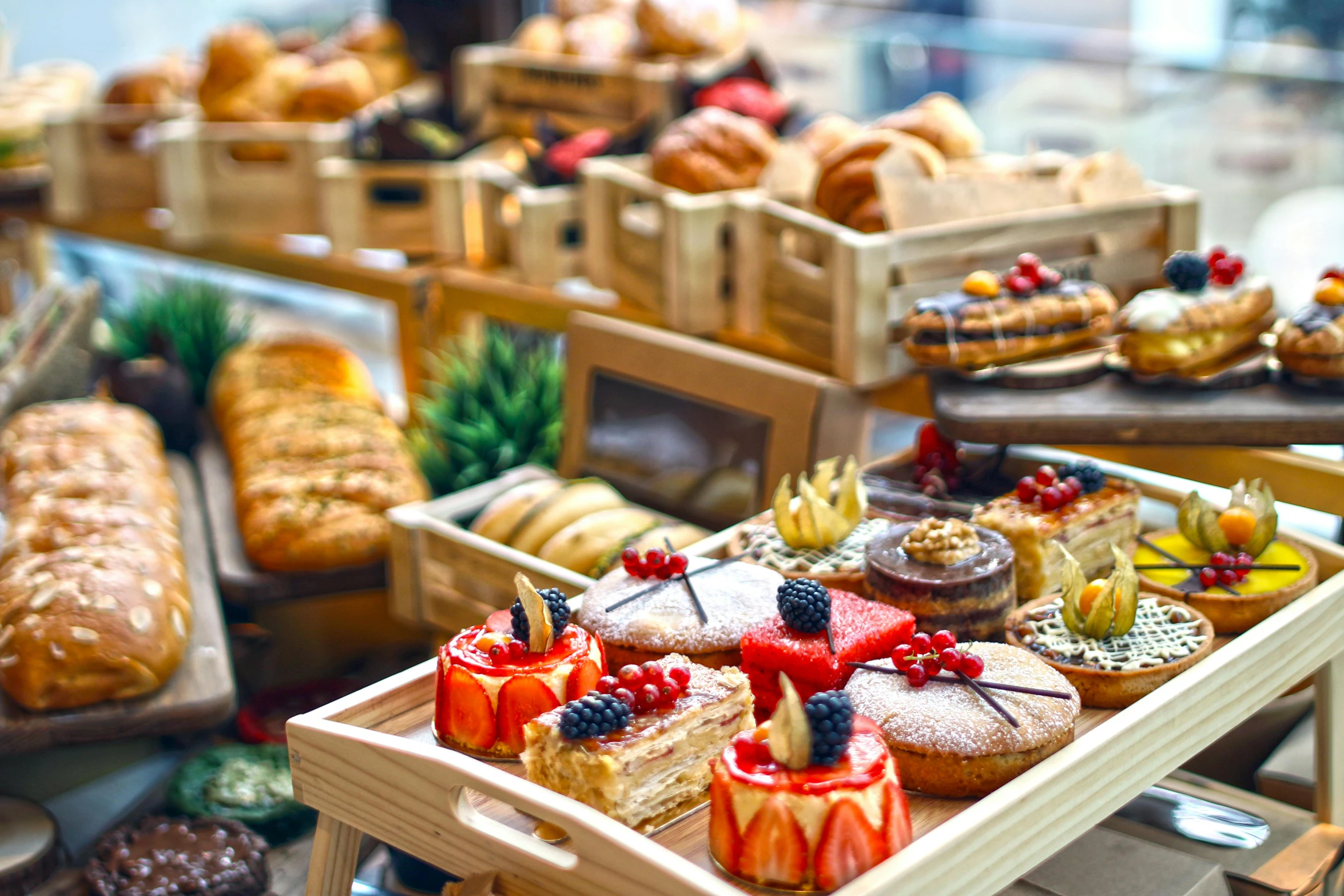 a display case filled with lots of different types of pastries, a still life, unsplash, renaissance, overflowing feast buffet table, profile image, lots of sunlight, 🦩🪐🐞👩🏻🦳