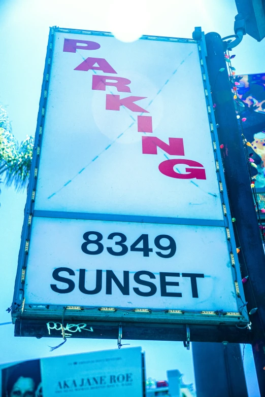 a close up of a sign on a pole, an album cover, inspired by L. A. Ring, trending on reddit, sunset lighting 8k, parking lot, tourist photo, sunshaft