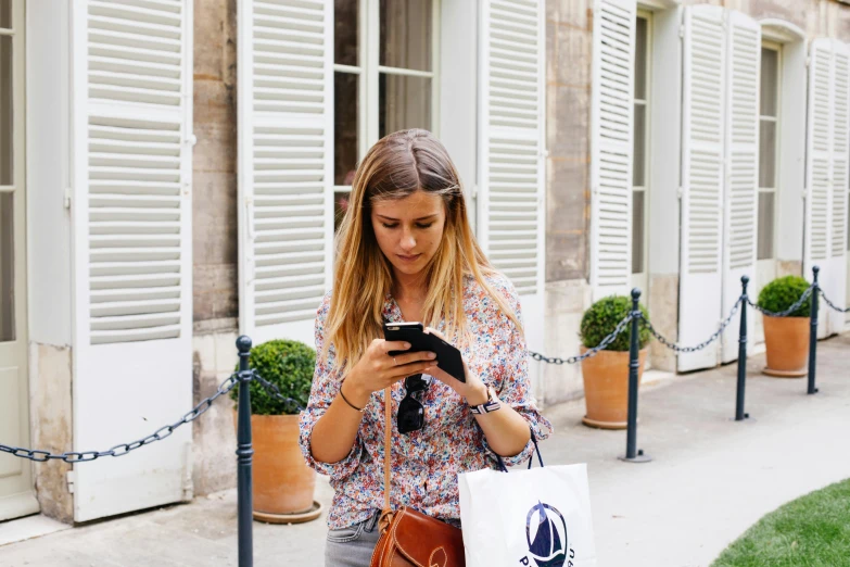 a woman walking down a sidewalk looking at her cell phone, pexels contest winner, figuration libre, french girl, scanning items with smartphone, loosely cropped, marie - gabrielle capet style