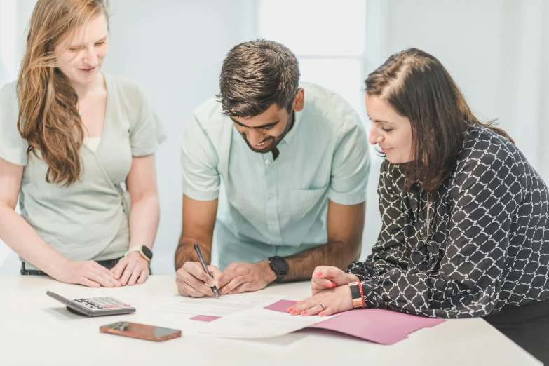 a group of people sitting around a white table, profile image, 9 9 designs, writing on a clipboard, healthcare