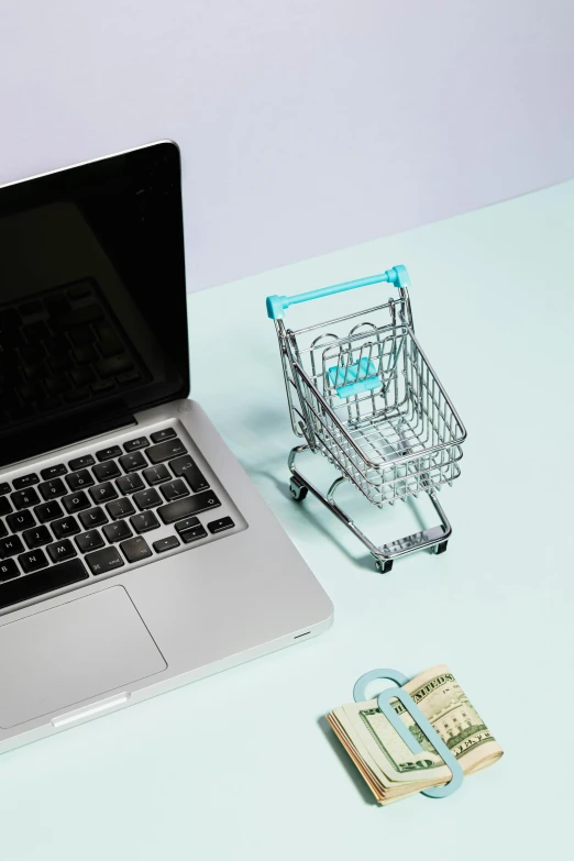 a laptop computer sitting on top of a desk next to a shopping cart, by Matthias Stom, trending on unsplash, japanese collection product, multiple stories, miniature product photo, digital image