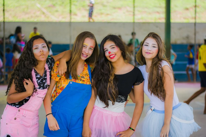 a group of young women standing next to each other, by Amelia Peláez, pexels, facepaint, summer camp, wearing a fancy dress, teenager girl