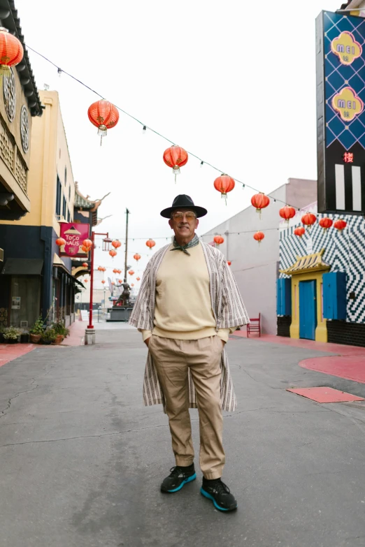 a man standing in the middle of a street, by William Berra, black arts movement, china town, older male, california, lgbtq