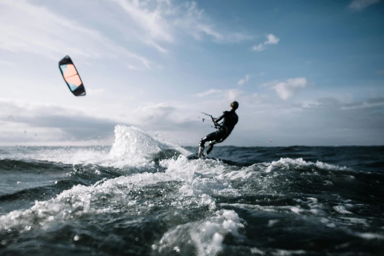 a man riding a wave on top of a surfboard, a picture, unsplash contest winner, figuration libre, kites, let's get dangerous, profile image, high light on the left