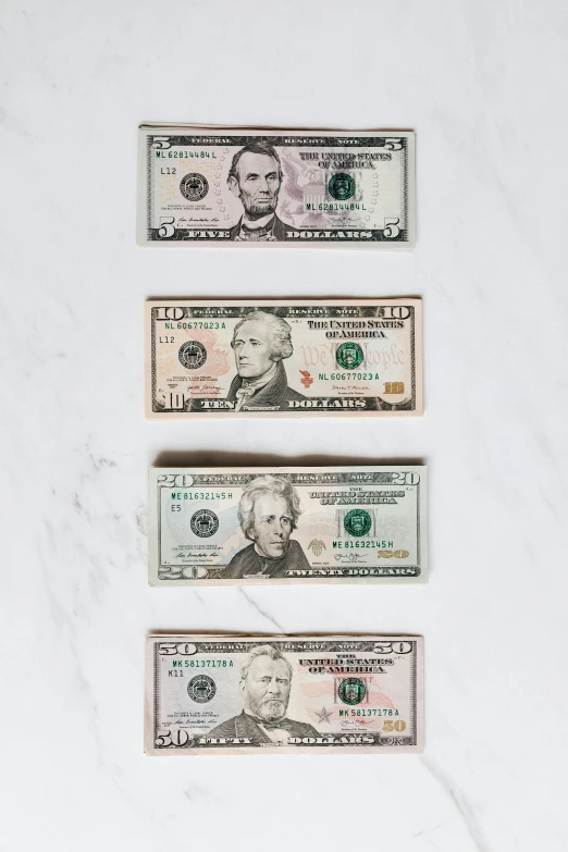 a bunch of money sitting on top of a counter, on a white table, half image, american total portrait, trending on vsco