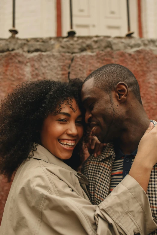 a man and woman hugging in front of a brick wall, trending on pexels, renaissance, east african man with curly hair, happy girl, grey skinned, hearts