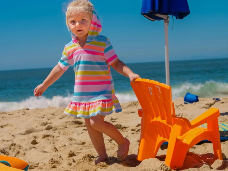 a little girl standing on top of a sandy beach, striped orange and teal, splash house, rainbow clothes, award-winning