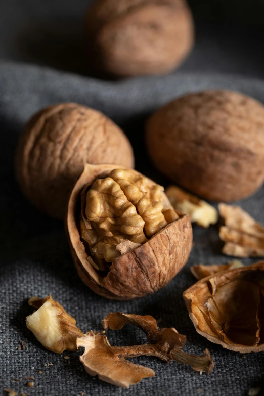 a bunch of walnuts sitting on top of a table, a portrait, trending on pexels, 1 6 x 1 6, silk, subtle detailing, 6 pack